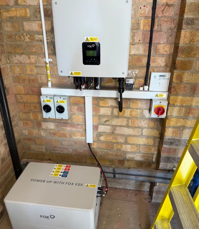 Fox ESS power system installed on brick wall.