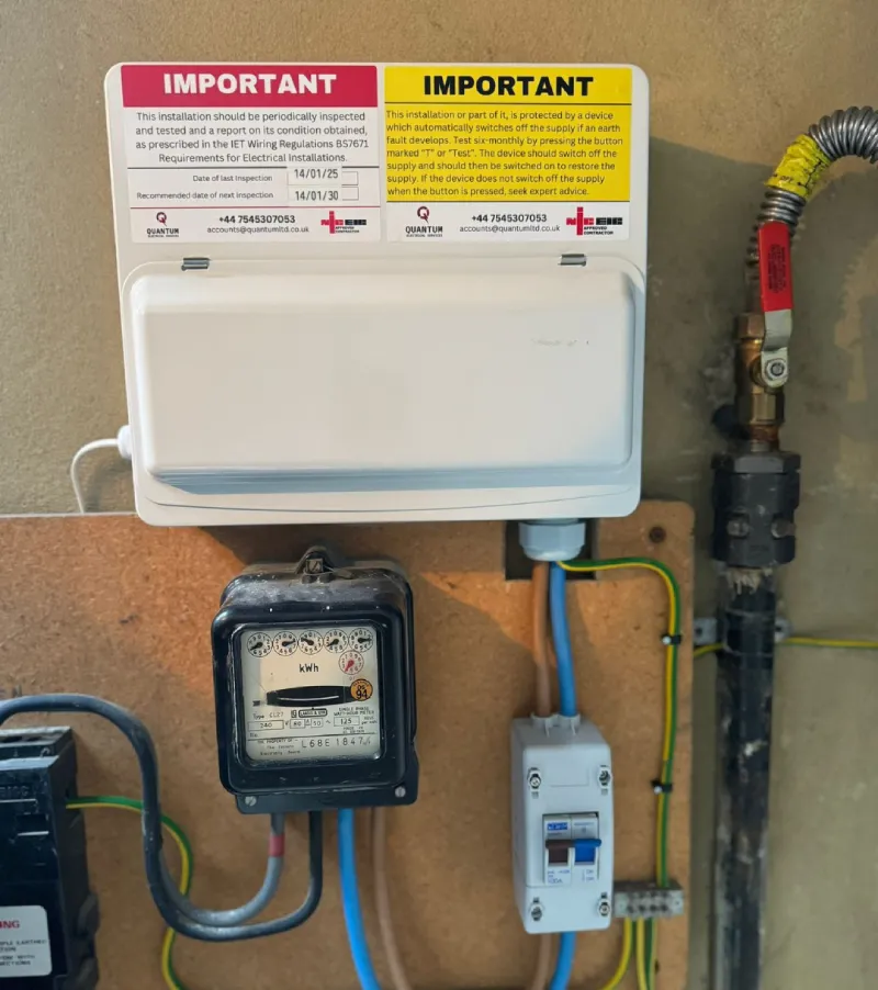 Electrical panel with meter and warning labels.